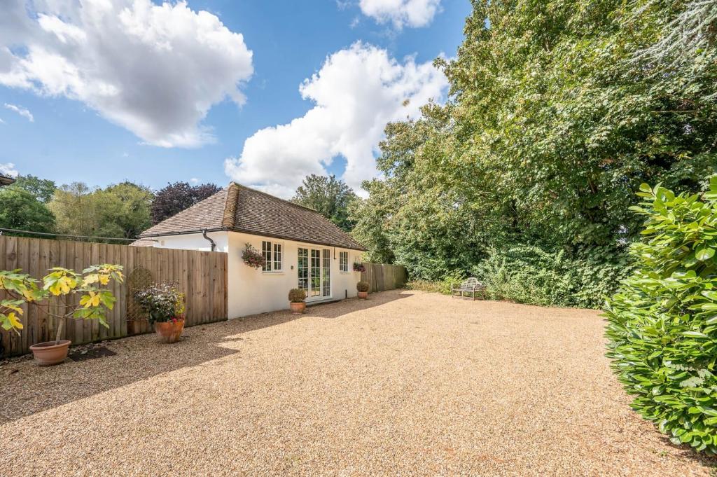 a cottage in a garden with a fence at Greenacres, Kelsale in Kelsale