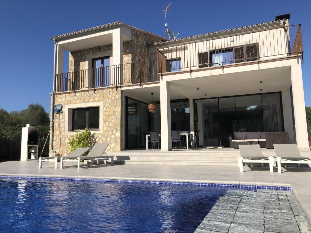 a house with a swimming pool in front of it at Trebol in Sa Pobla