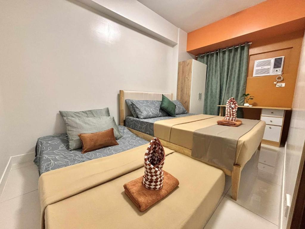 a small room with two beds and a couch at Luxurios 1 bedroom unit horizons101 in Cebu City