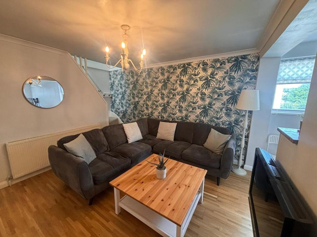 a living room with a couch and a coffee table at Stylish & Spacious 2 Storey, 3 Bed Apartment in Kent