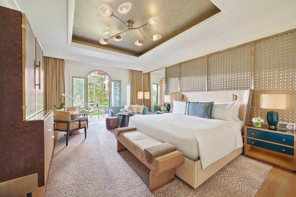 a bedroom with a large bed and a living room at Emirates Palace Mandarin Oriental, Abu Dhabi in Abu Dhabi