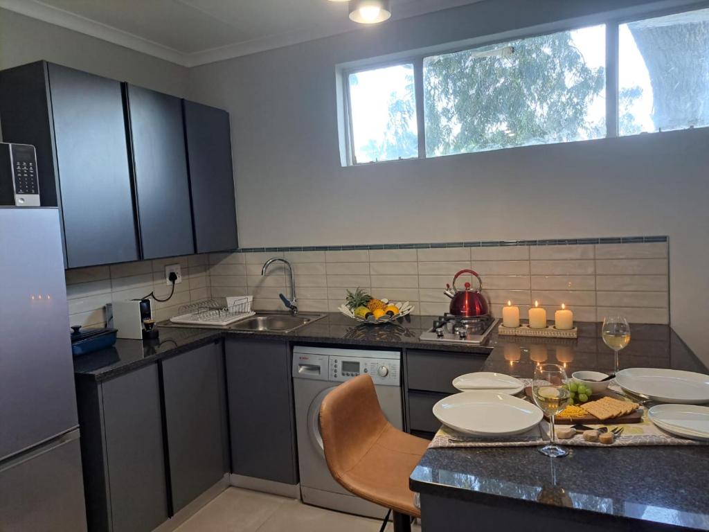 a kitchen with a table with plates on it at Hadeda Road 3 in Johannesburg