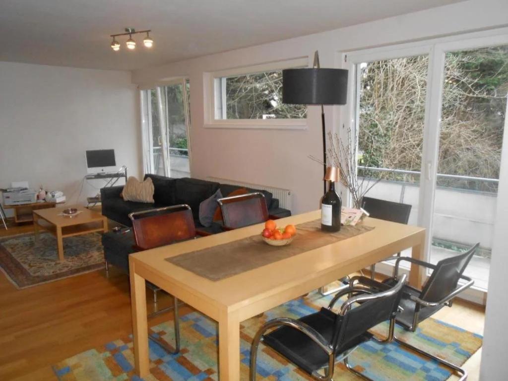 a living room with a wooden table and chairs at Dornbirn Zentrum Bahnhof in Dornbirn