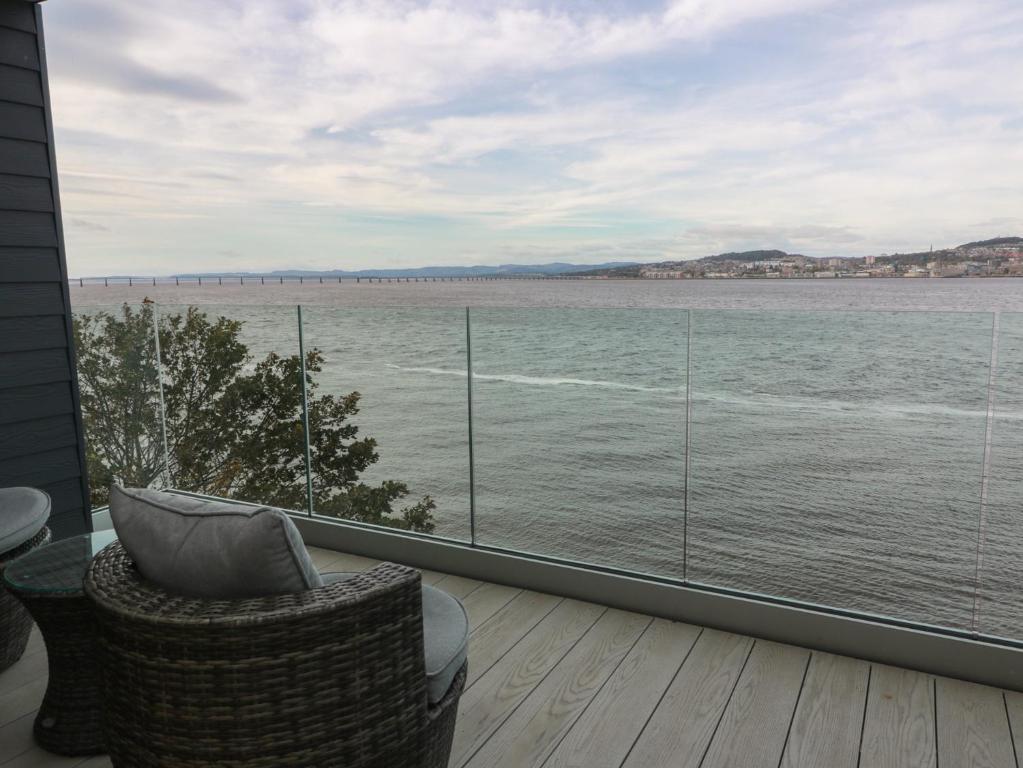 a balcony with a view of the water at Lazy Bulldog in Newport-On-Tay