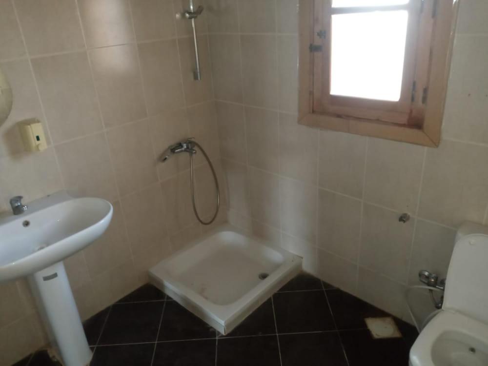 a bathroom with a shower and a sink and a toilet at جزيره سهيل in Aswan