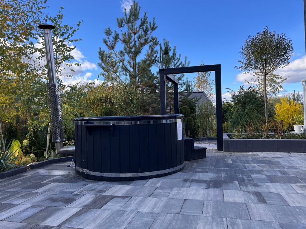 a large black tub sitting on top of a patio at Bukove Love in Sobącz