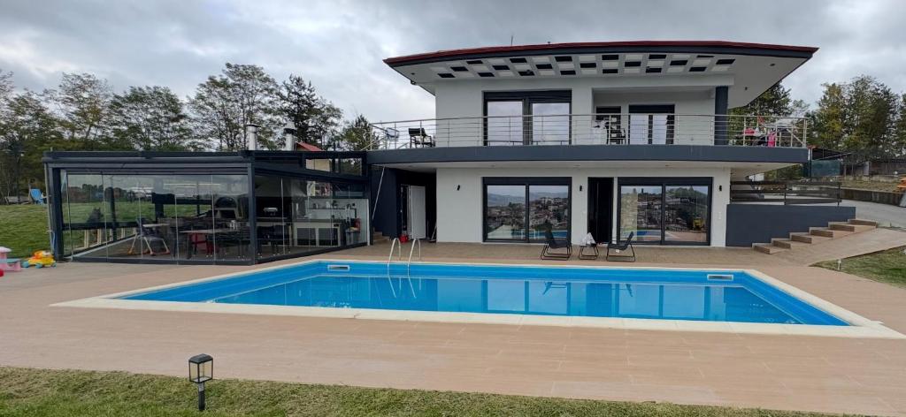 a large house with a swimming pool in front of it at Villa Rafaela in Grevena in Grevena