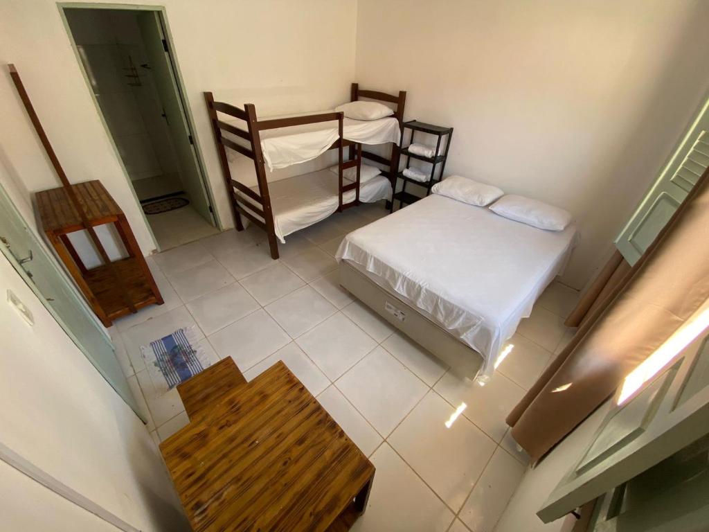 an overhead view of a room with two beds and a table at Hospedagem Raiz Vida in Itacaré