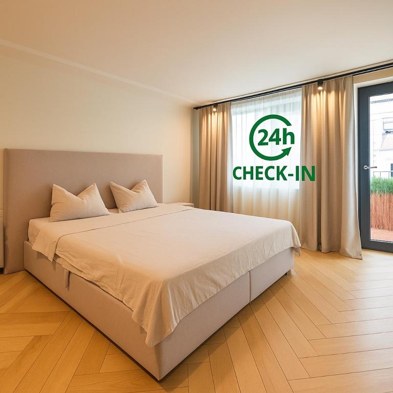 a bedroom with a bed with a check in sign on the window at Origin Central Apartment in Cluj-Napoca