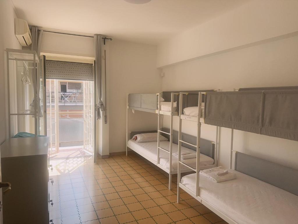 a room with two bunk beds and a window at Lisa HOUSE in Rome