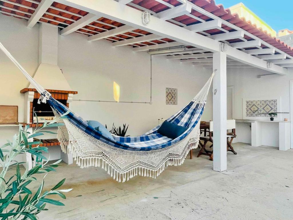 a hammock hanging from a pergola in a house at Pijamas House 2 in Gafanha da Encarnação