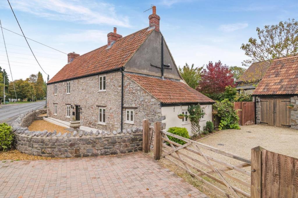 an old stone house with a fence in front of it at 5 Bed in Cleeve oc-t33614 in Brockley