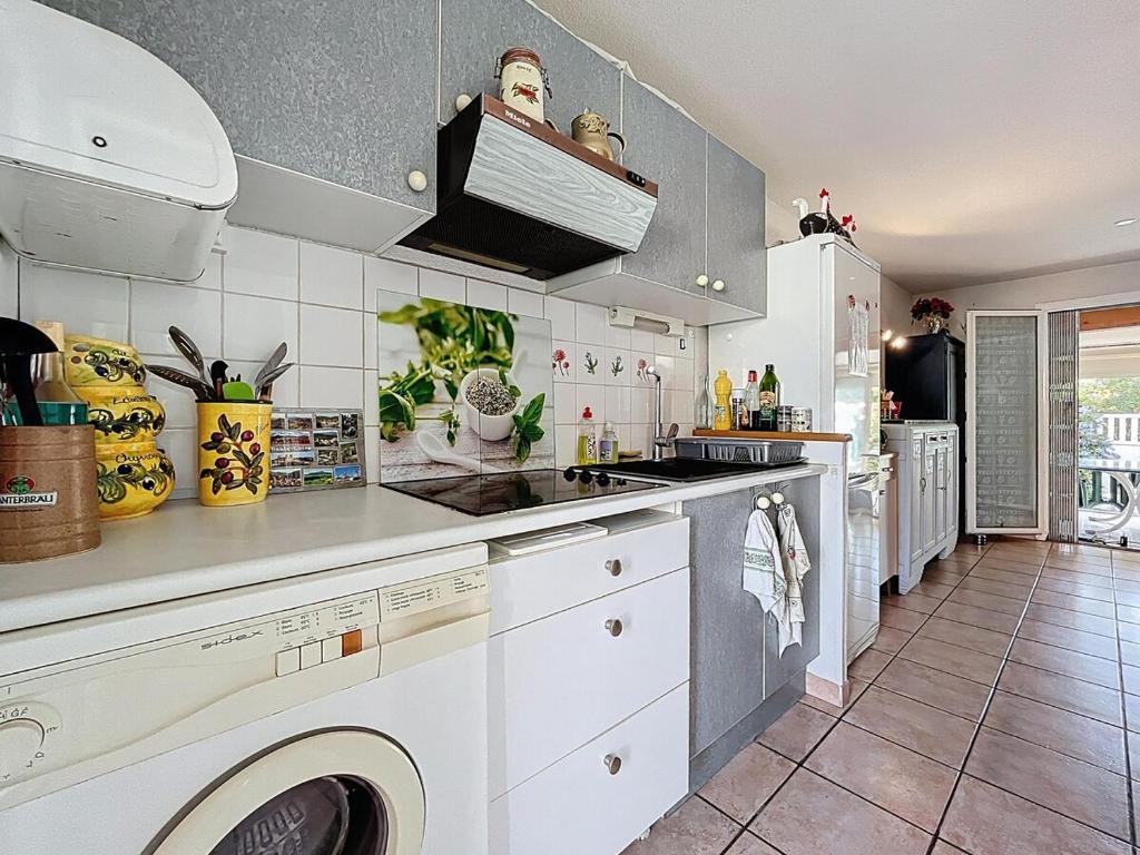 a kitchen with a washer and dryer in it at L'Ulysse - 5pers - Climatisation - plage à 200 m in Narbonne
