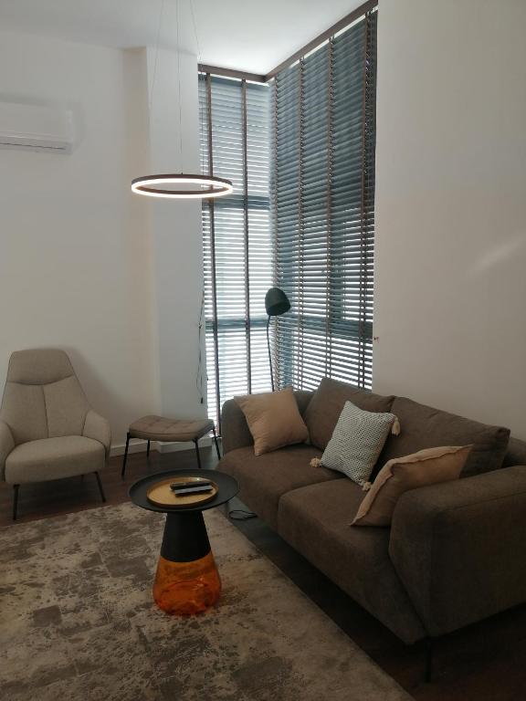 a living room with a couch and a table at Apartament 60 in Koszalin