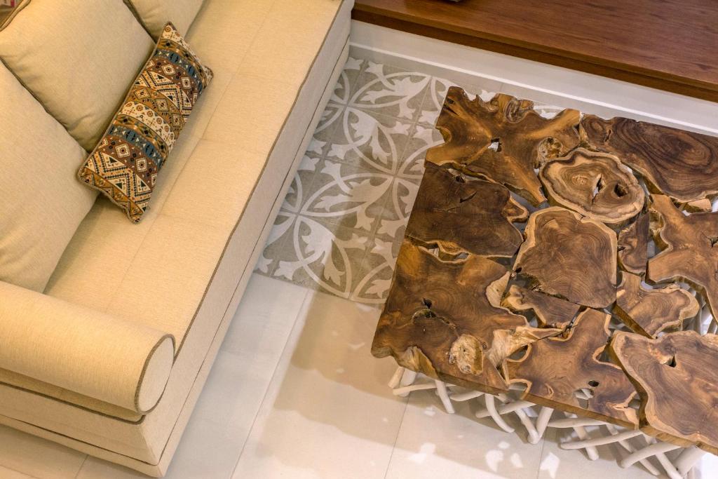 a rug on the floor next to a couch at Golden Bay Suites & Maisonettes in Parga