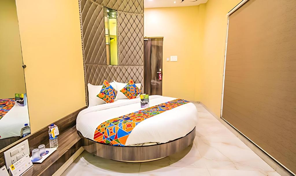 a bedroom with a large bed in a room at Glitz Hotels New Seven Hills - Nr International Airport Mumbai in Mumbai