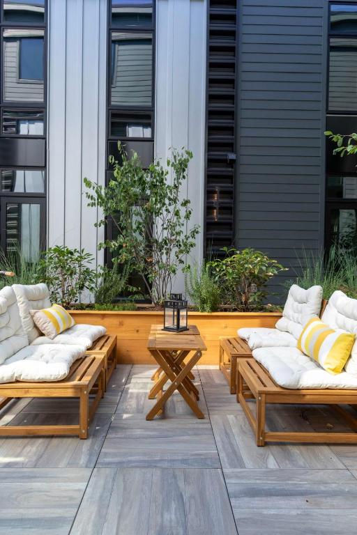 a patio with two benches and a table at Inkwell Charlotte in Charlotte
