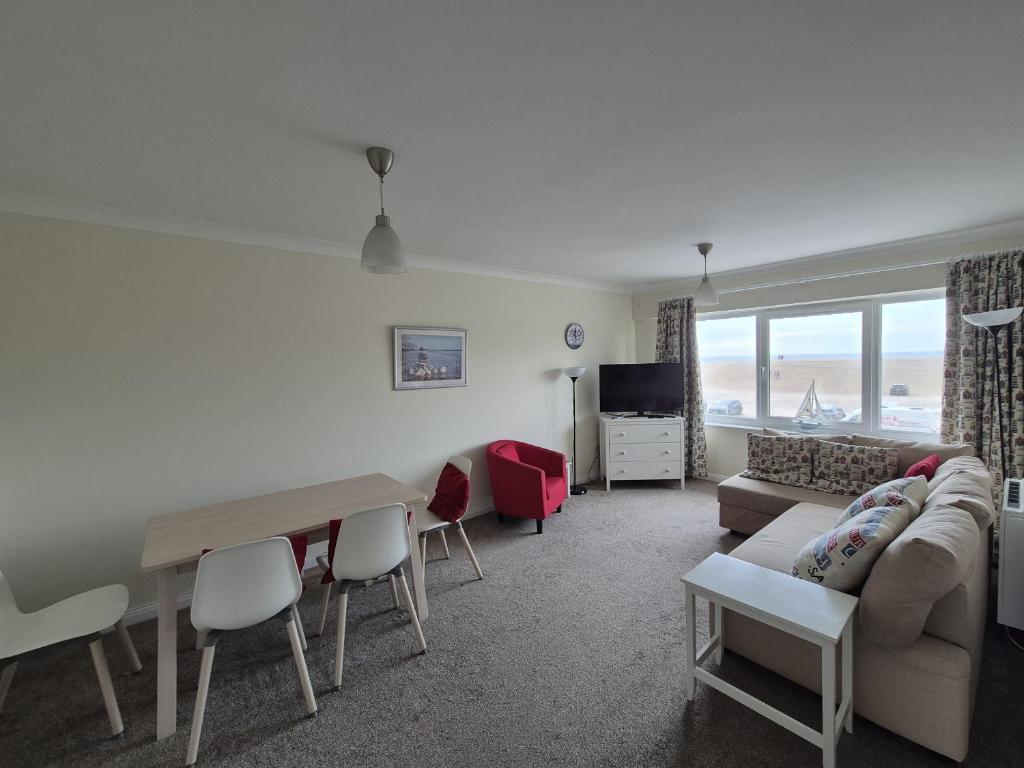 a living room with a couch and a table at Jurassic View in West Bay