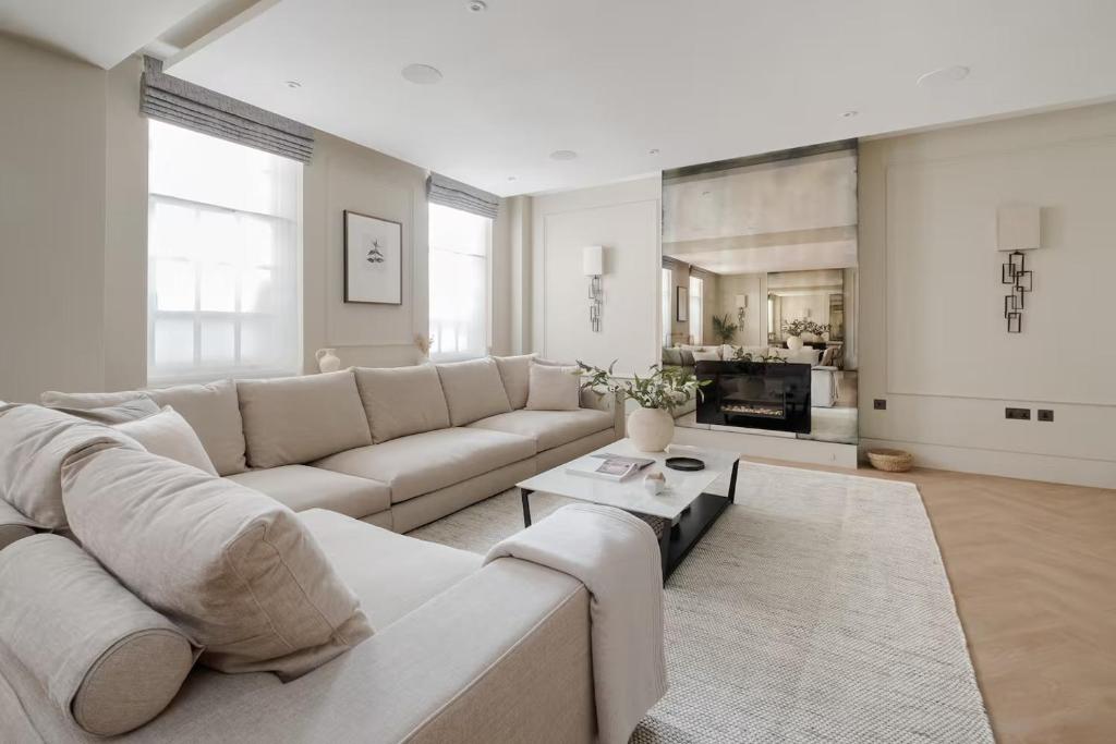 a white living room with a couch and a table at Comfortable Luxury apartments near the Center - London in Solihull