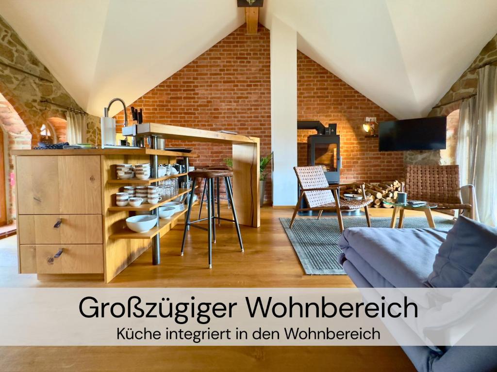 a living room with a couch and a brick wall at HexenburgbeiDresden 2 Zimmer Architektenwohnung mit eigener Sauna, Whirlwanne und Kamin - Nähe Sächsische Schweiz Dresden in Großharthau