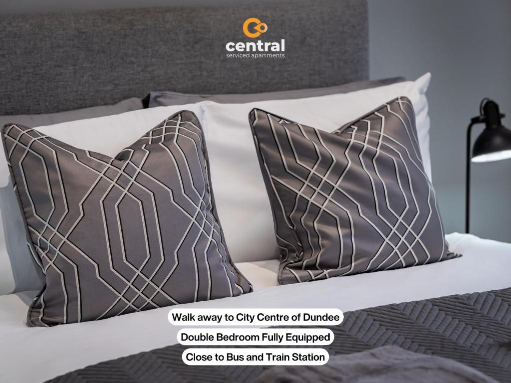 a couple of pillows sitting on a bed at Trades Lane by CENTRAL SERVICED APARTMENTS - Cosy 1 Bedroom - Walk Away From City Quay V&A - Walk to Bus and Train Station - Easy Access to City Centre - Fast Wi-Fi - Fully Equipped - Weekly & Monthly Stay Offers in Dundee