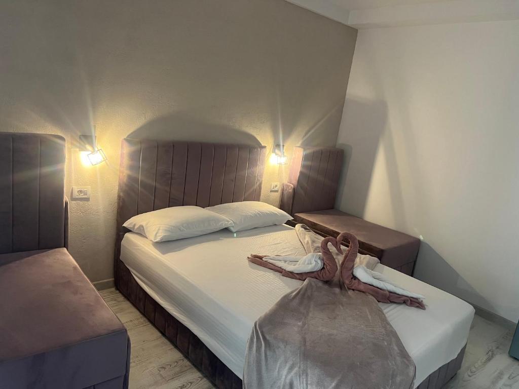 a hotel room with a bed with a dress on it at Ama boutique in Constanţa