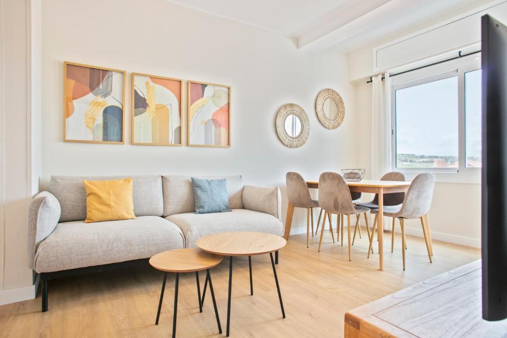 a living room with a couch and a table at Alcam Terrassa in Terrassa