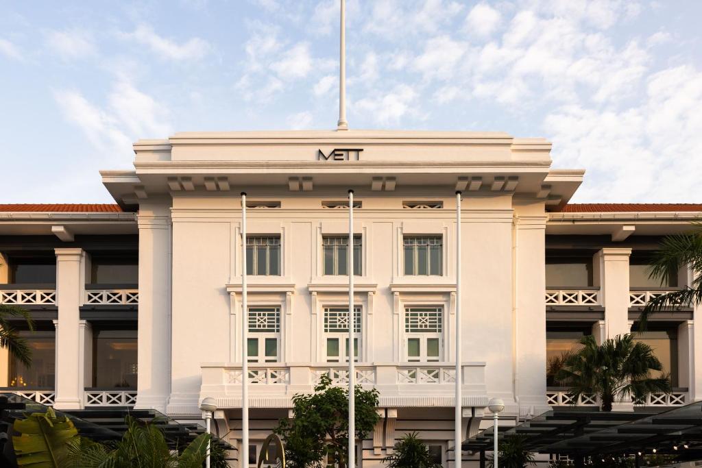 a white building with the nir sign on it at METT Singapore in Singapore