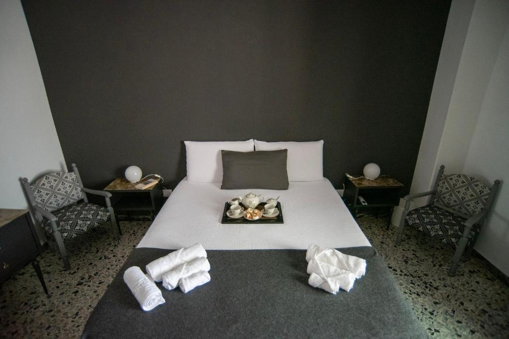 a bedroom with a bed with a tray of food on it at Casa Scano in Morgongiori