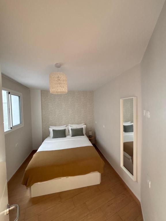 a bedroom with a bed and a chandelier at Verana House in Arguineguín