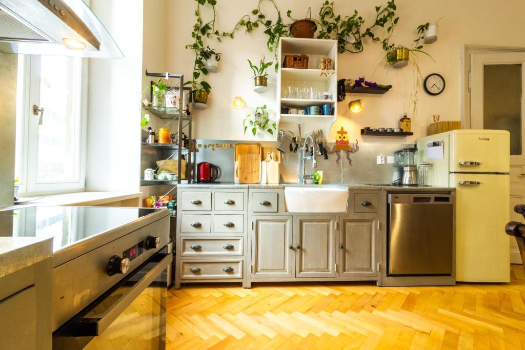 a kitchen with white cabinets and stainless steel appliances at Family place in Old town/center in Liberec