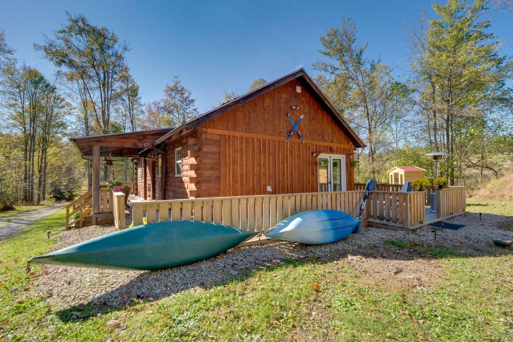 two kayaks on the ground in front of a cabin at 7 Mi to Bilgers Rocks Secluded 7-Acre Retreat in Clearfield