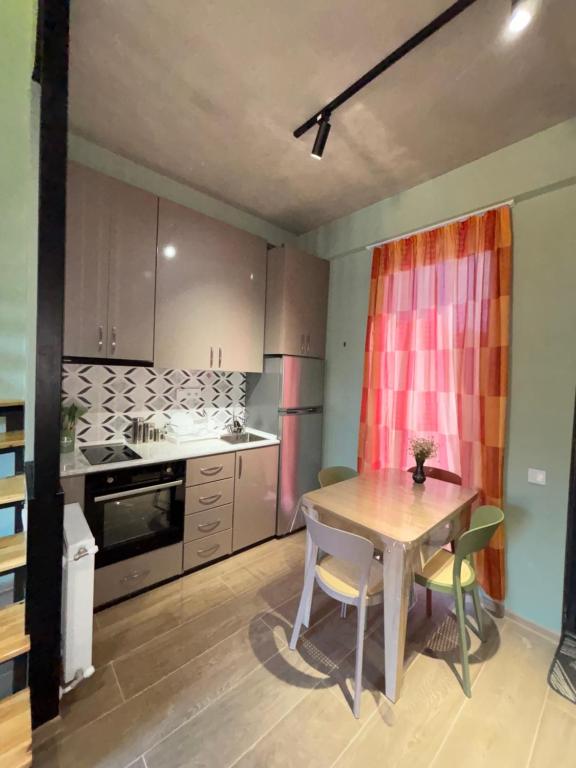 a kitchen with a table and chairs in a room at Sama Bakuriani in Itʼkhvisi