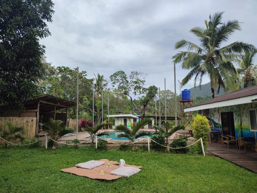 a resort yard with a pool and a house at Eco Greene Farm in Puerto Princesa City
