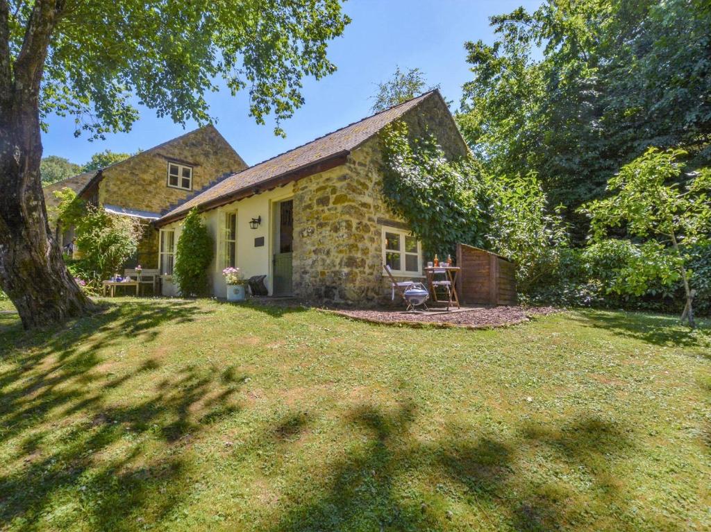 a stone house with a large yard at 1 Bed in Netherbury DC021 in Netherbury
