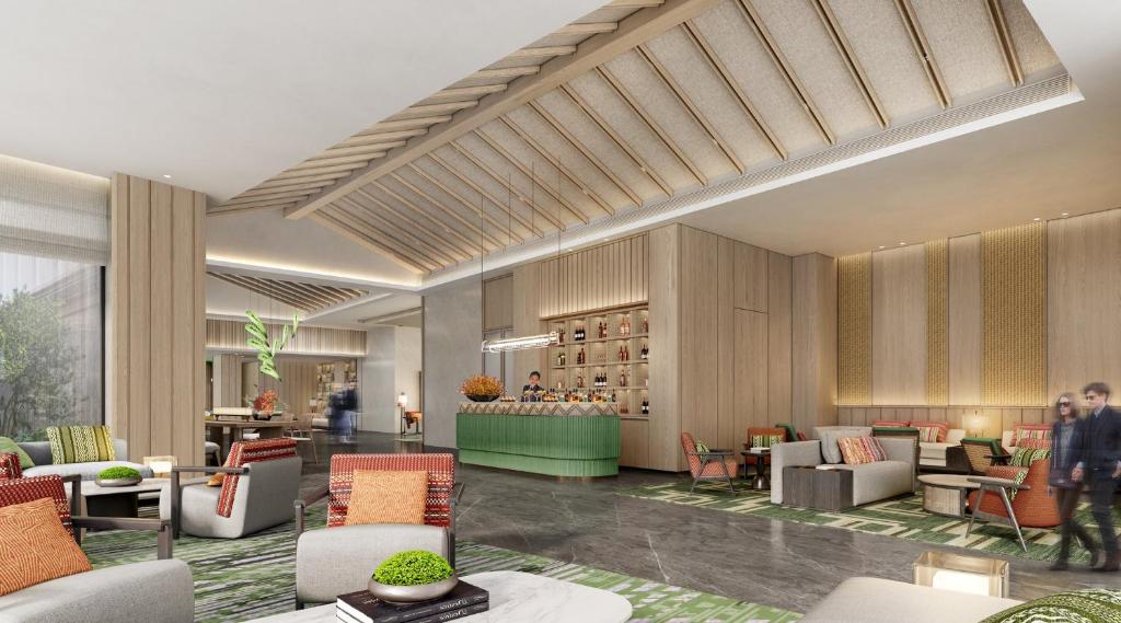 een weergave van een lobby met banken en stoelen bij Holiday Inn Pu'er Jingmai by IHG in Mengman