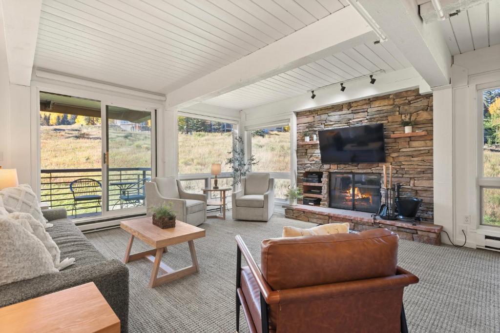 a living room with a fireplace and a tv at Enclave 209, Snowmass Ski-In/Ski-Out Condo w/Shared Pool/Hot Tub in Snowmass Village