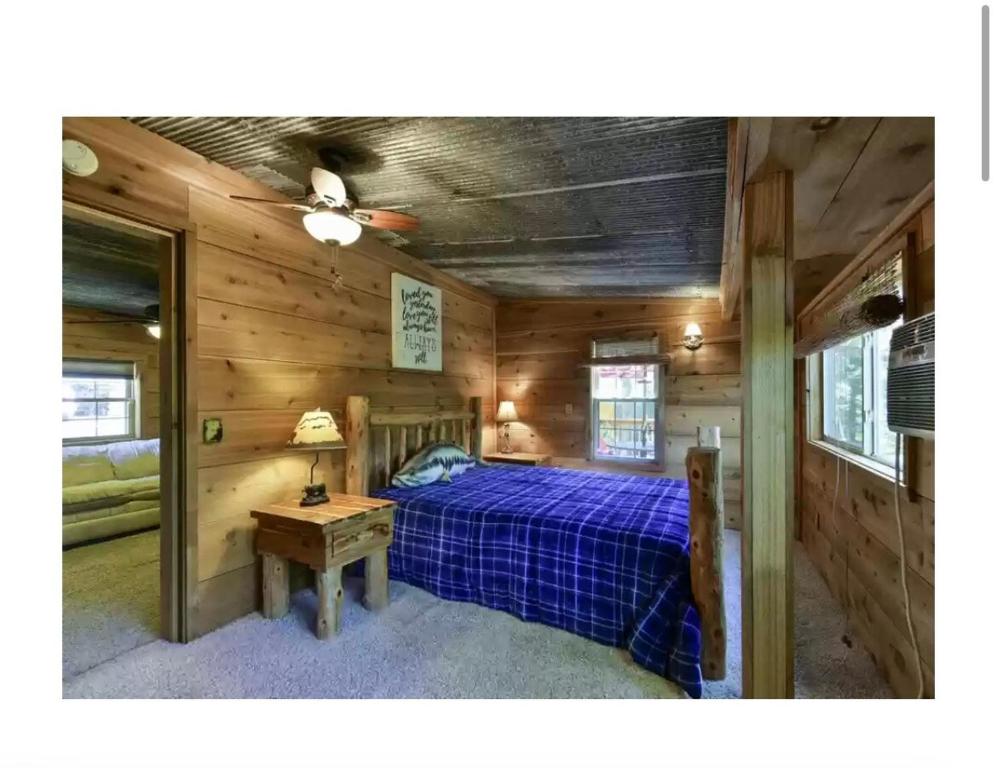 a bedroom with a bed in a wooden cabin at Cozy Lake Cabin in Eagle Rock