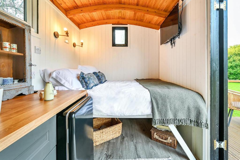 a small bedroom in a tiny house at Deer Shepherds Hut in Hartfield