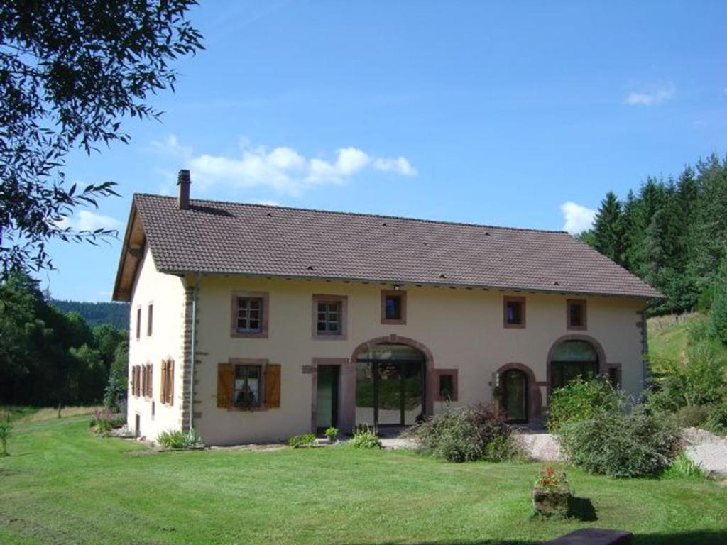 a large white house on a grass field at Grande Ferme Rénovée avec Jardin, Terrasse et Sentiers à Proximité - Vosges - FR-1-589-232 in Taintrux
