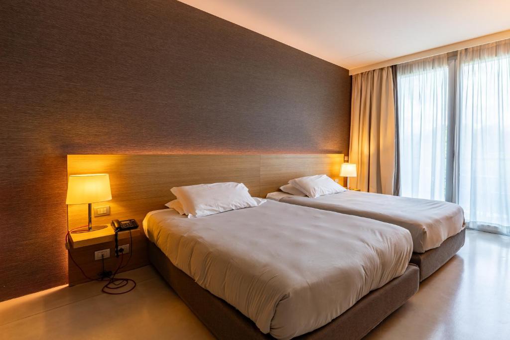 Ένα ή περισσότερα κρεβάτια σε δωμάτιο στο HSM Hotel San Martino