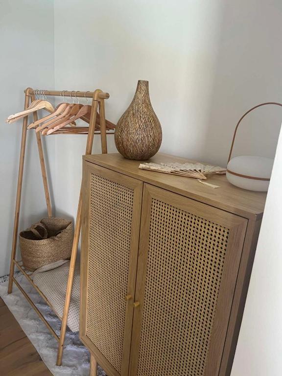 a wooden cabinet with a vase on top of it at The best view in Marezige