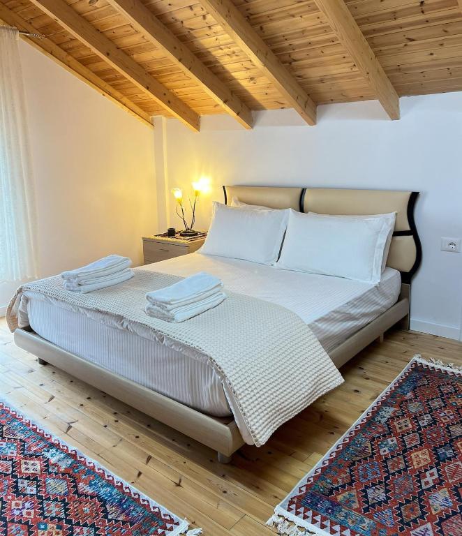 a bedroom with a bed with two towels on it at Vila Hysaj in Kamëz