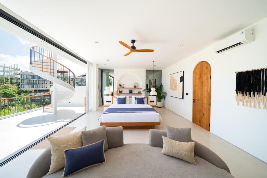 a bedroom with a bed and a balcony at Elements Villa B1 - Rooftop, Pool & 5-Min to Beach in Bingin Beach