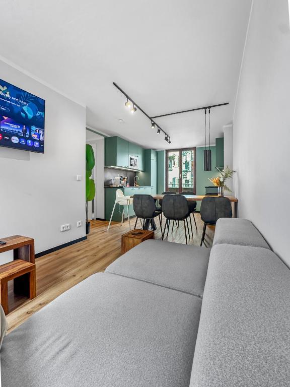 a living room with a couch and a dining room at Flatista Homes - Herzog Heinrich in Munich