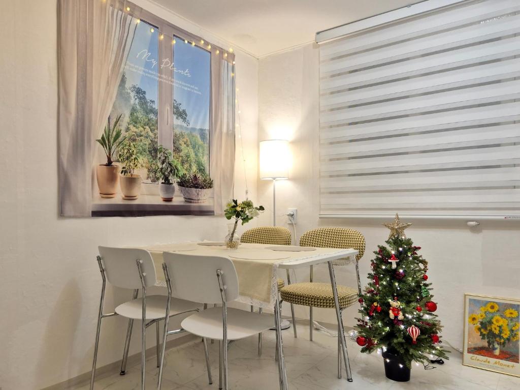 a dining room with a table and a christmas tree at Stay Ok - Amsa Station 암사역도보2분 KSPO LOTTEWORLD 올림픽경기장 롯데월드 롯데타워 아산병원 in Seoul