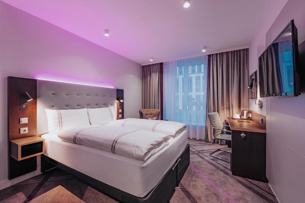 a hotel room with a large bed and a television at Premier Inn Rosenheim City Lokhöfe in Rosenheim