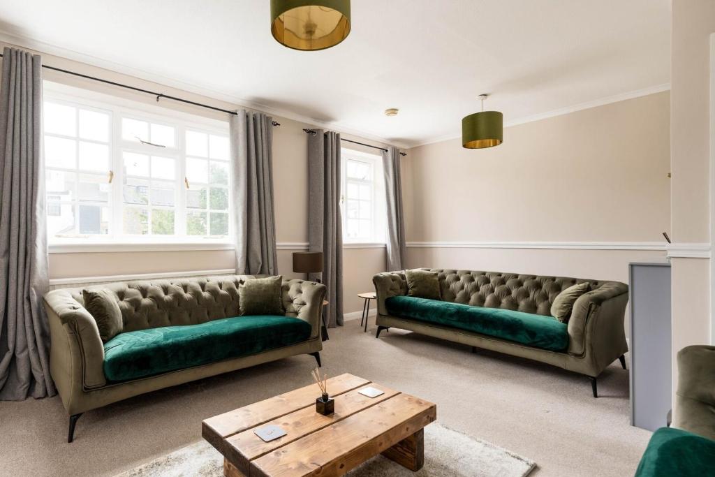 a living room with two couches and a table at Tranquil 3BD Haven by the Sea in Littlehampton in Littlehampton