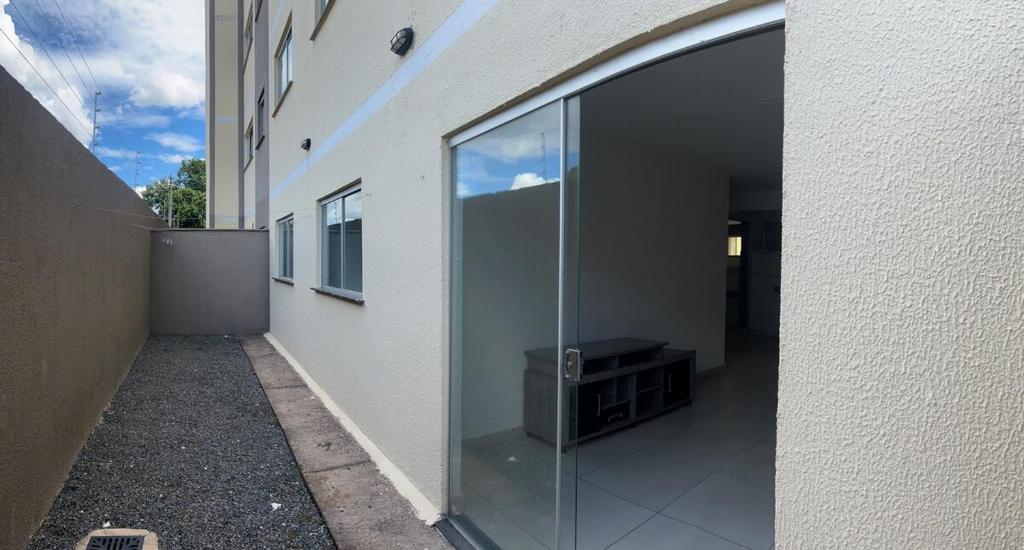 a large glass window on the side of a building at Apartamento Aconchego in Luziânia
