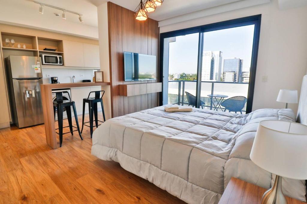 a bedroom with a large bed and a large window at Stylish Retreat Steps from Shopping del Sol in Asuncion